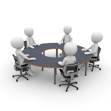 Cartoon of people around a circular meeting table.